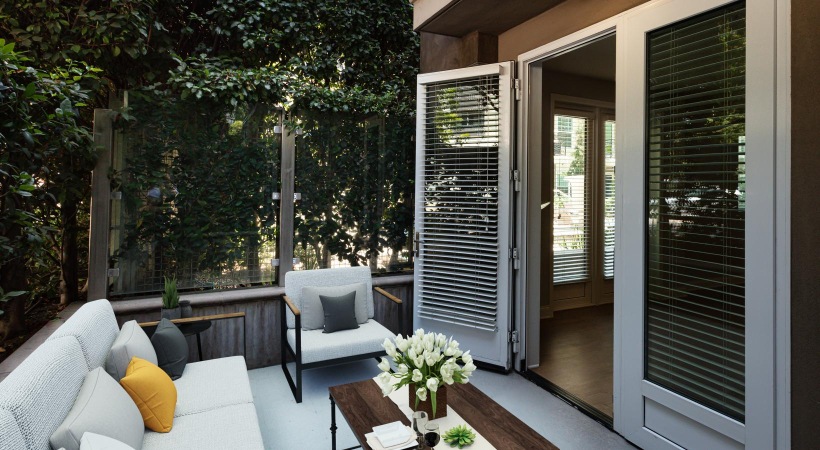 a patio with a table and chairs